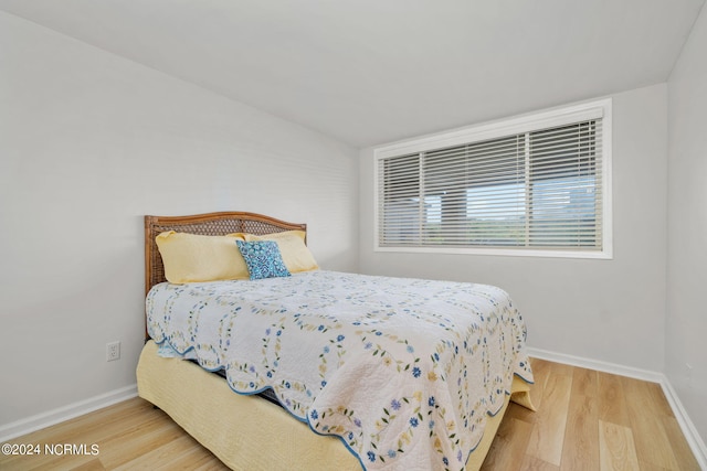 bedroom with hardwood / wood-style floors