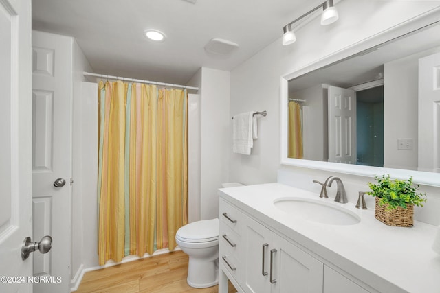 bathroom with vanity, hardwood / wood-style floors, and toilet