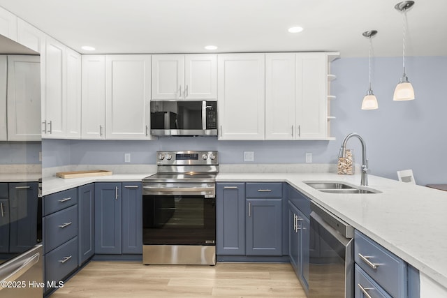 331 Salter Path Rd Unit 104, Pine Knoll Shores, NC 28512 - kitchen with appliances with stainless steel finishes, a sink, white cabinets, blue cabinets, and recessed lighting