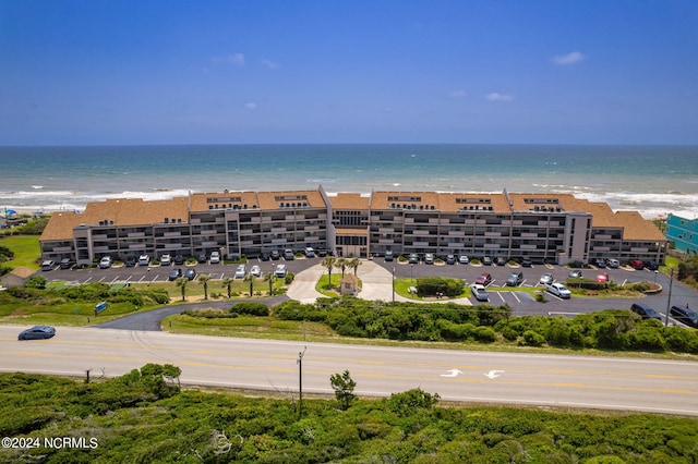 drone / aerial view featuring a beach view and a water view