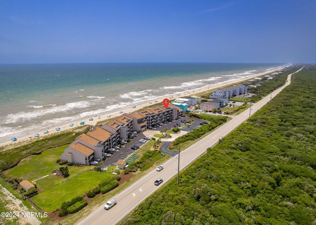 drone / aerial view with a water view and a beach view