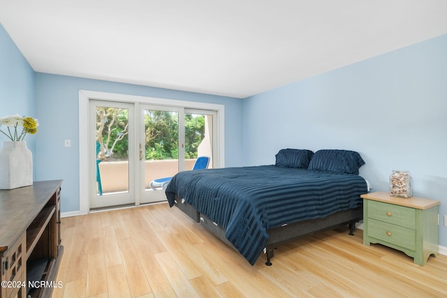 bedroom with access to outside and light hardwood / wood-style flooring