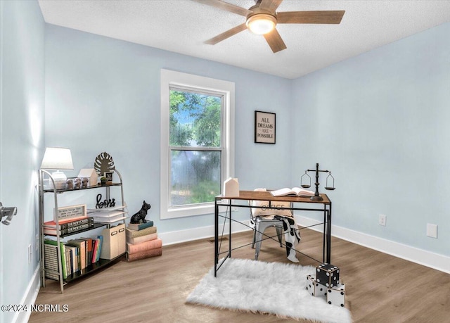 office space featuring ceiling fan, wood-type flooring, and a textured ceiling