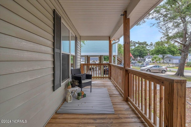 wooden terrace featuring covered porch