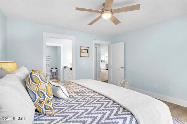 bedroom featuring connected bathroom, hardwood / wood-style flooring, and ceiling fan