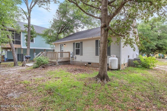 rear view of property featuring a deck