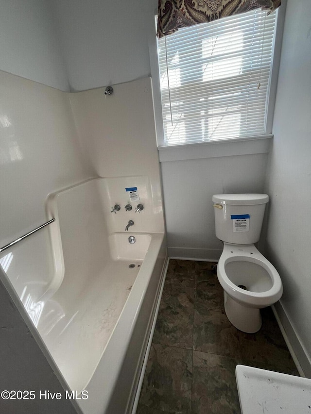 105 Hazel St, Woodland, NC 27897 - bathroom with baseboards, a washtub, and toilet