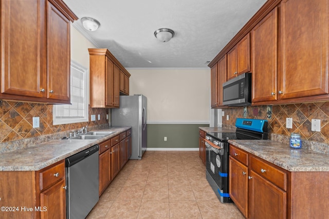 kitchen with decorative backsplash, sink, light tile patterned floors, and stainless steel appliances