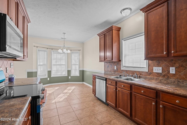 kitchen featuring decorative backsplash, a wealth of natural light, sink, and appliances with stainless steel finishes