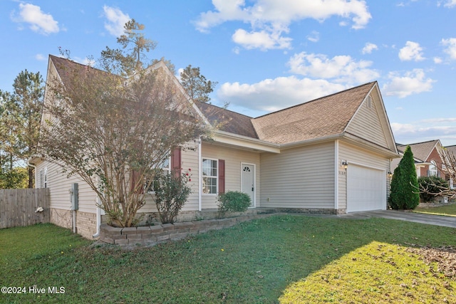 view of front of house with a front yard and a garage