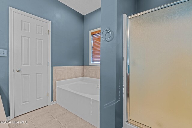 bathroom with tile patterned floors and plus walk in shower