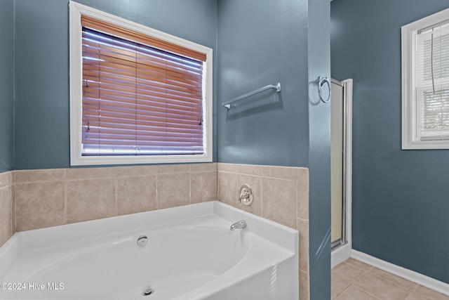 bathroom featuring tile patterned floors and independent shower and bath