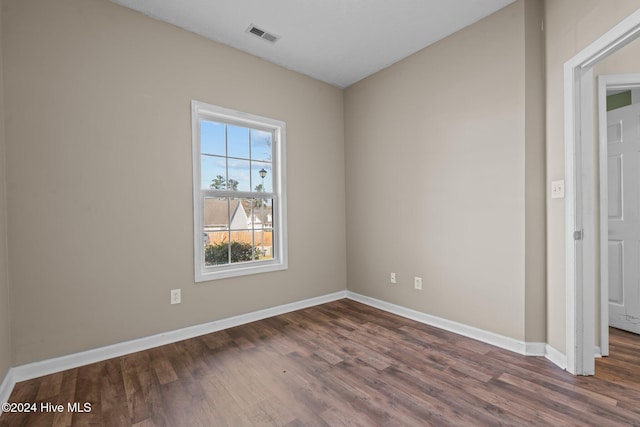 empty room featuring dark wood-type flooring