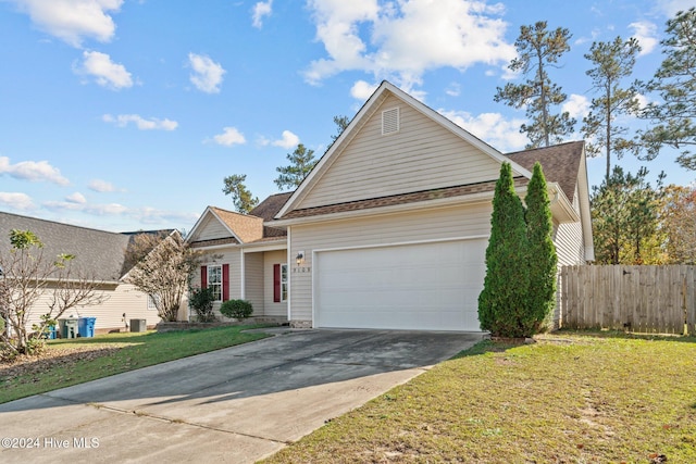 view of front of home featuring a garage and a front yard