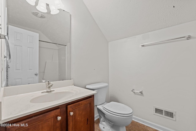 bathroom featuring vanity, a textured ceiling, and lofted ceiling