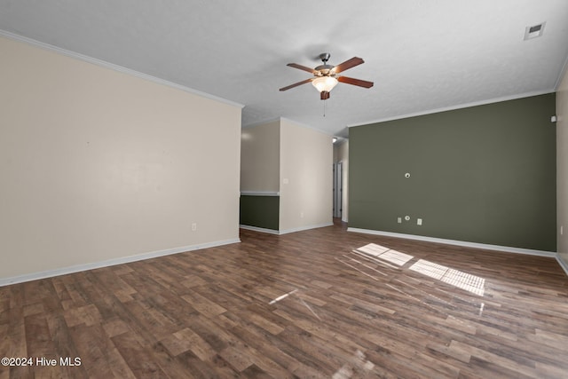 empty room with a textured ceiling, crown molding, ceiling fan, and dark wood-type flooring