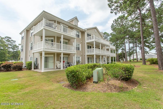 back of property featuring a lawn