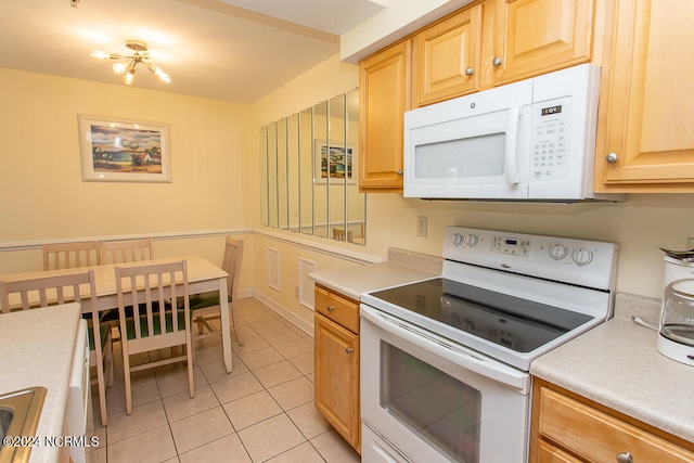 kitchen with white appliances and light tile patterned floors