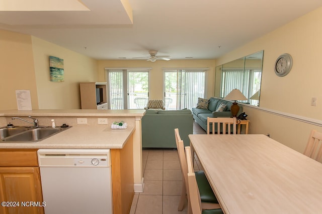 kitchen featuring white dishwasher, sink, light tile patterned floors, and ceiling fan