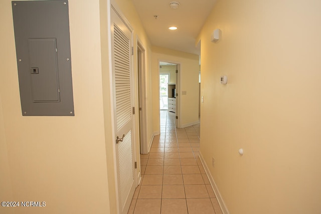 corridor with electric panel and light tile patterned floors