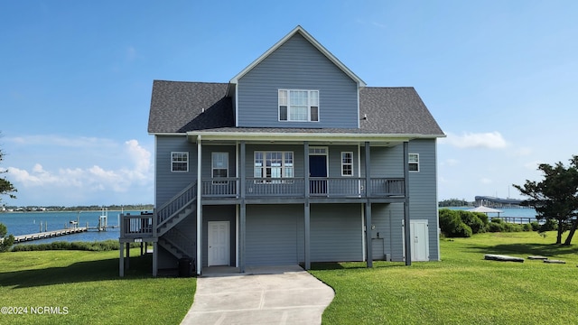 exterior space with a water view and a lawn