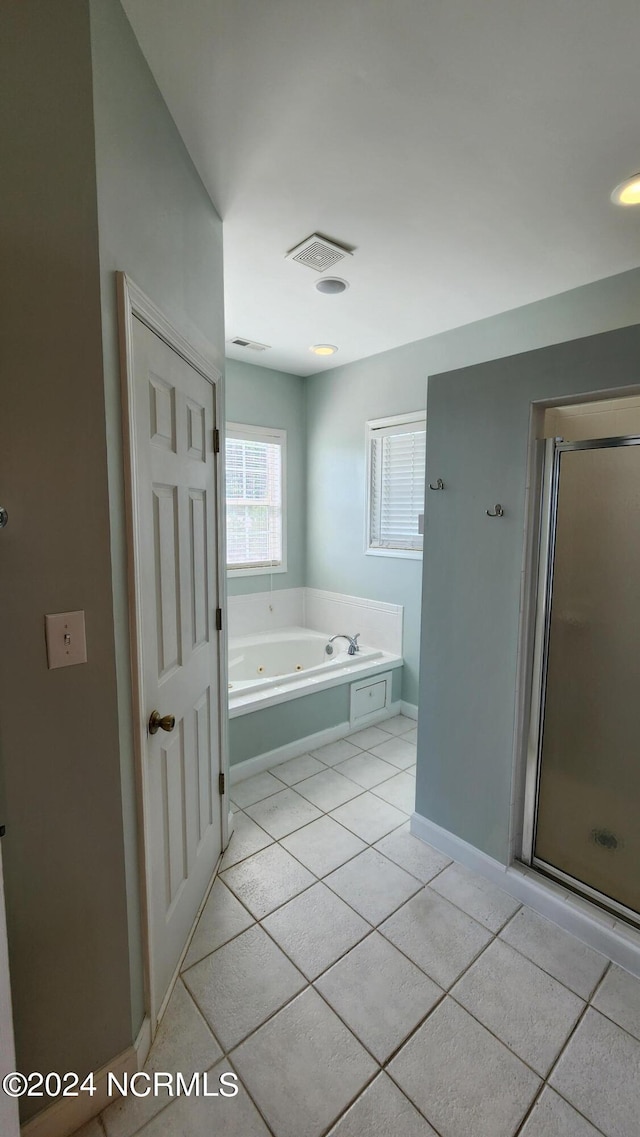 bathroom featuring tile patterned floors and shower with separate bathtub