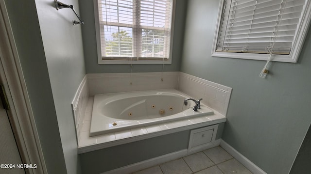 bathroom with a washtub and tile patterned floors