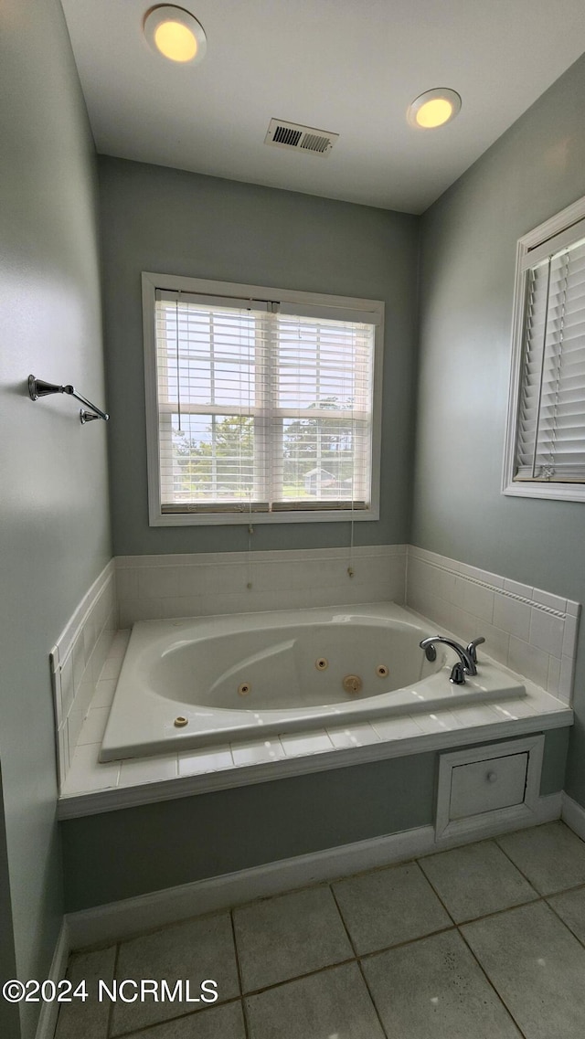 bathroom featuring a tub to relax in and tile patterned floors