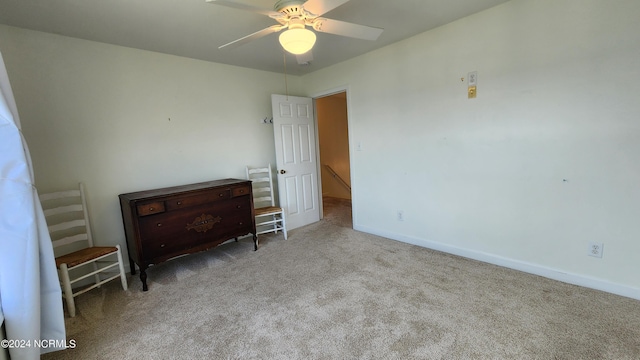 unfurnished bedroom featuring ceiling fan and light colored carpet