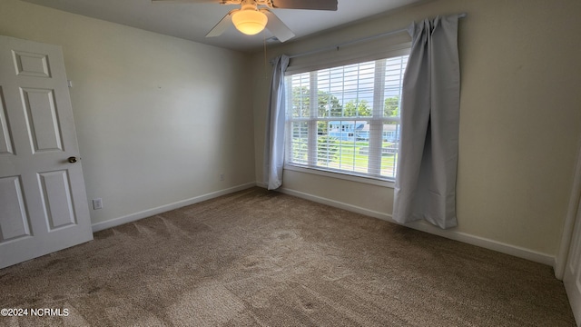 carpeted spare room with ceiling fan