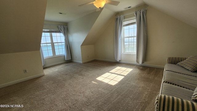 bonus room featuring ceiling fan, light colored carpet, and lofted ceiling