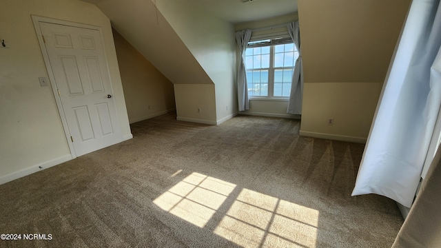 bonus room featuring carpet flooring and vaulted ceiling