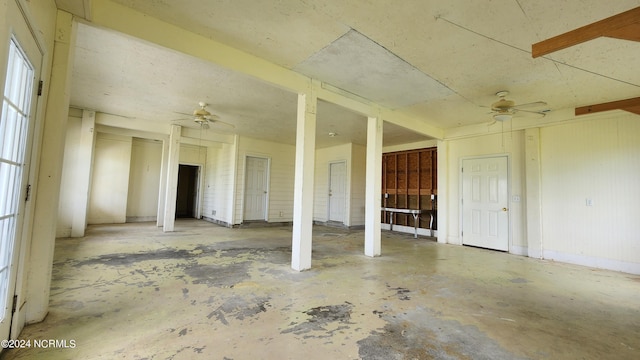 interior space with concrete floors and ceiling fan