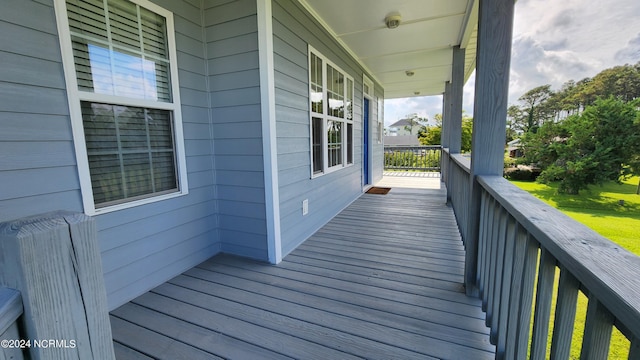 wooden terrace featuring covered porch and radiator