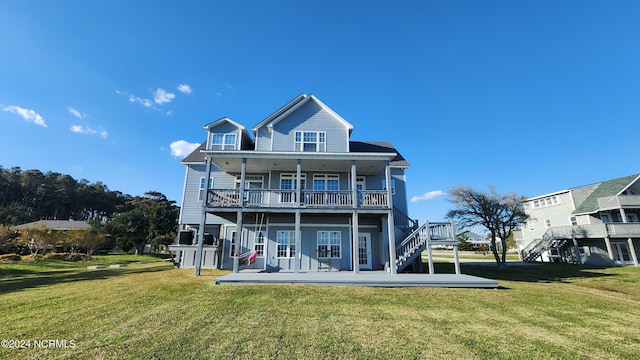 back of house featuring a balcony and a yard