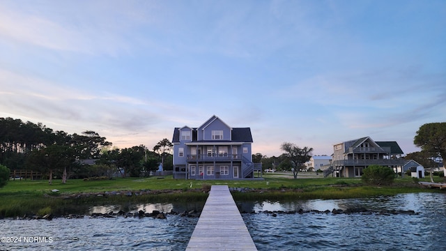 dock area with a water view and a balcony