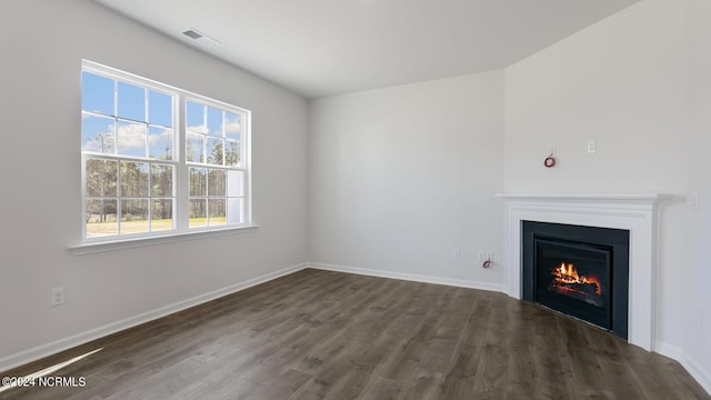 unfurnished living room with dark hardwood / wood-style floors