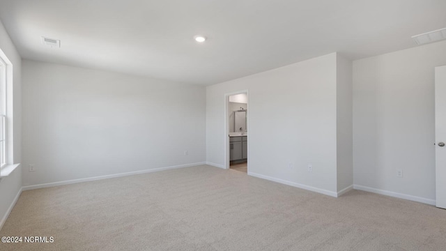 empty room featuring light colored carpet