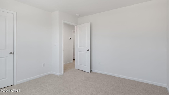 unfurnished bedroom featuring light colored carpet