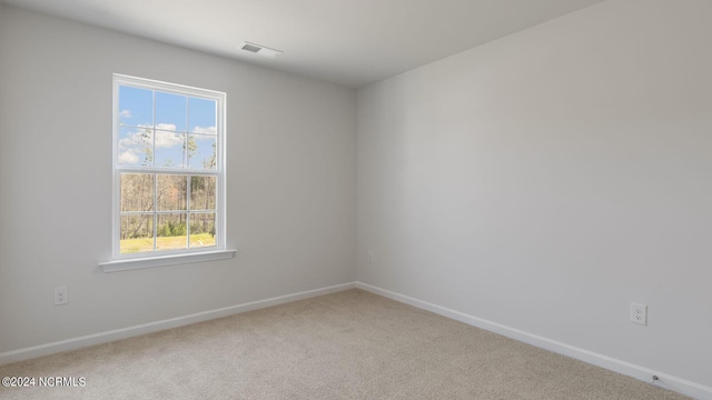 carpeted empty room featuring plenty of natural light