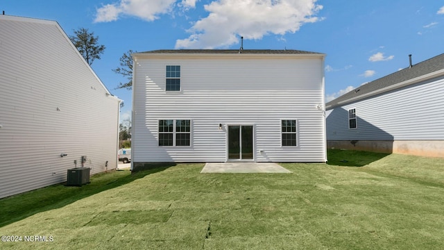 rear view of house featuring a yard, a patio, and central AC