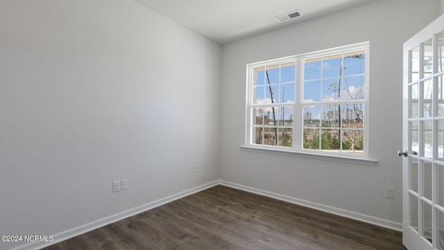 spare room with dark hardwood / wood-style flooring