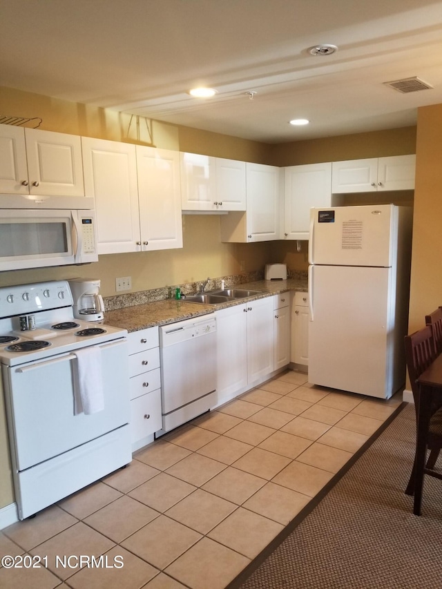 kitchen featuring sink, white cabinets, white appliances, and light tile patterned floors