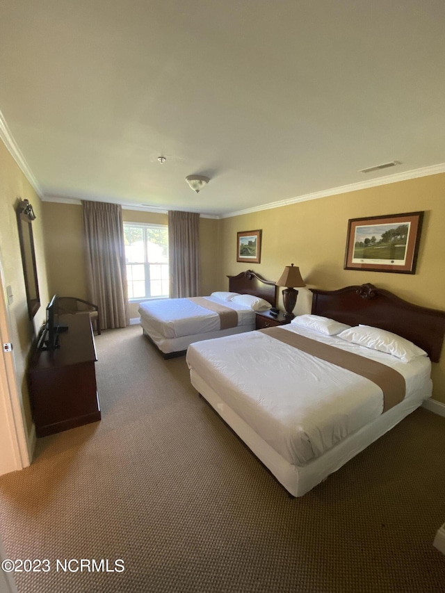 carpeted bedroom with ornamental molding