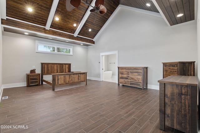 bedroom with beam ceiling, connected bathroom, high vaulted ceiling, and wood ceiling