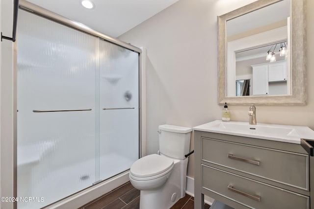 bathroom with vanity, toilet, and walk in shower