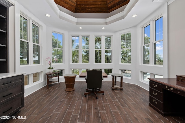 sunroom / solarium featuring a raised ceiling