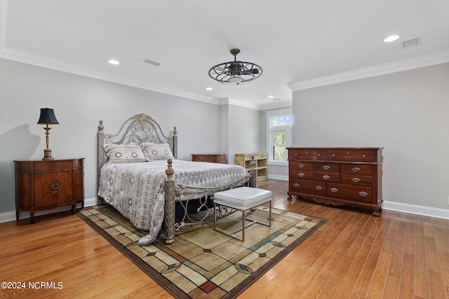 bedroom featuring hardwood / wood-style floors and crown molding