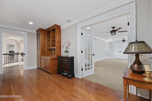 interior space featuring light hardwood / wood-style flooring and ornamental molding