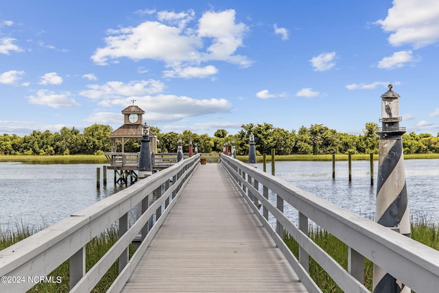 view of dock with a gazebo and a water view